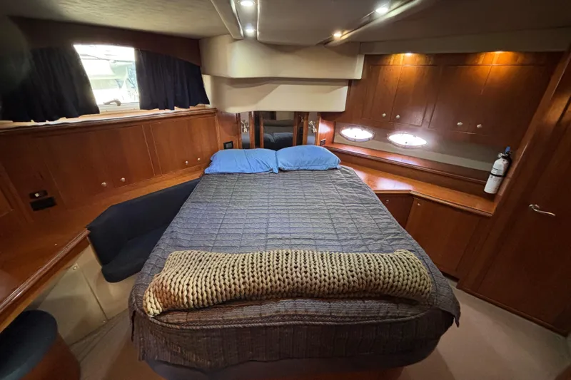 Liberty Call Yacht Photos Pics Luxurious cabin interior of 2005 Cruisers Yachts 455 Express Motoryacht Master Stateroom Island Queen Berth and luxurious Cherrywood Cabinetry