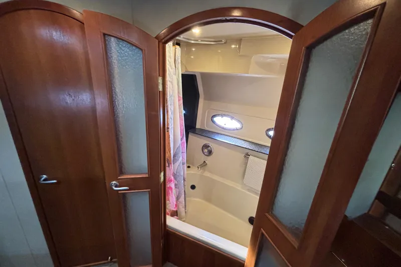 Liberty Call Yacht Photos Pics Luxurious bathroom in 2005 Cruisers Yachts 455 Express Motoryacht French Doors providing direct access to the Jacuzzi Tub from the Master Stateroom