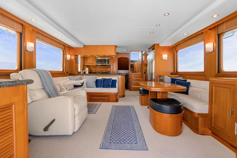  Yacht Photos Pics Luxurious interior of a 2007 Fleming 65 yacht with elegant wood finishes and plush seating.