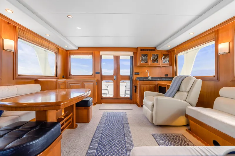  Yacht Photos Pics Luxurious interior of 2007 Fleming 65 yacht with elegant wood finishes and comfortable seating.