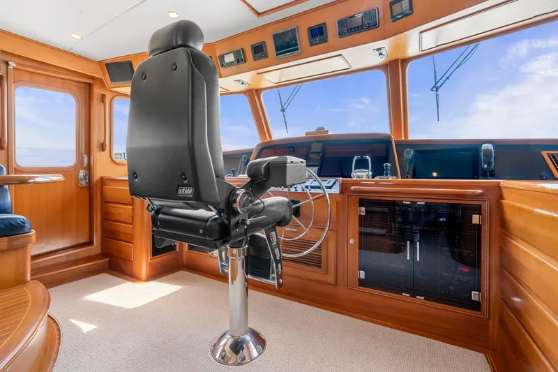  Yacht Photos Pics Pilothouse interior of 2007 Fleming 65 yacht with captain's chair and navigation controls.