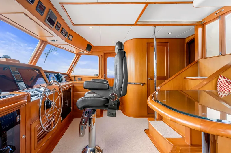  Yacht Photos Pics Luxurious 2007 Fleming 65 yacht helm with modern controls and elegant wood finish.