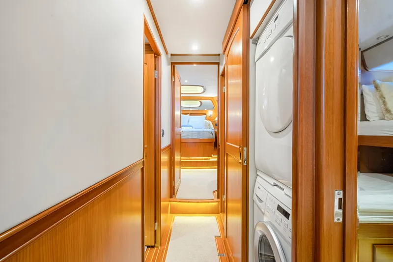 Yacht Photos Pics Hallway inside 2007 Fleming 65 yacht with wood paneling and laundry area.