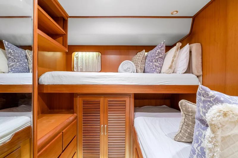  Yacht Photos Pics Luxurious wooden cabin interior of 2007 Fleming 65 yacht with cozy bunk beds.