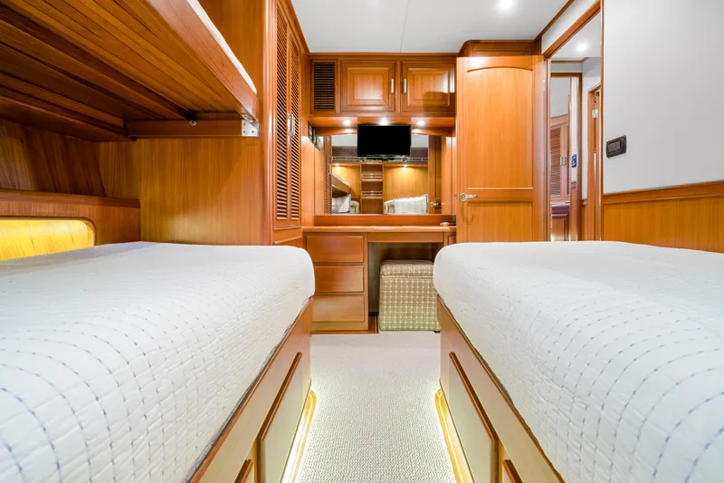  Yacht Photos Pics Luxurious 2007 Fleming 65 yacht cabin with twin beds and elegant wood finish.