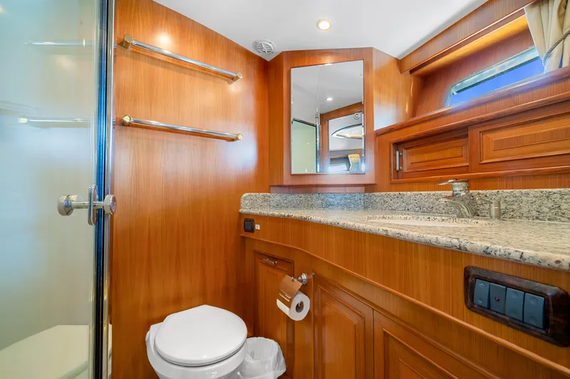  Yacht Photos Pics Luxurious bathroom in a 2007 Fleming 65 yacht with wood accents and granite countertop.