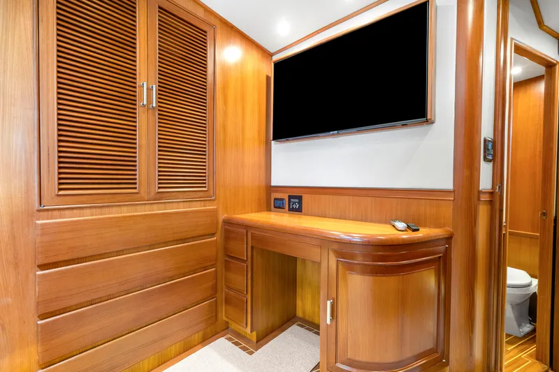  Yacht Photos Pics Luxurious wooden interior of 2007 Fleming 65 yacht with TV and cabinetry.