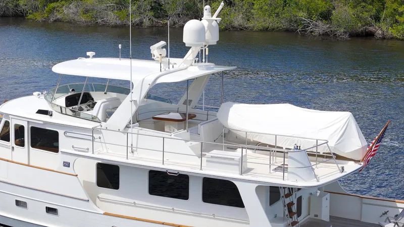  Yacht Photos Pics Luxury 2007 Fleming 65 yacht docked by lush greenery.