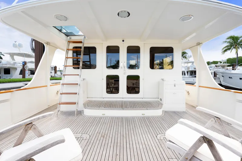  Yacht Photos Pics Luxury yacht deck of 2007 Fleming 65 with wooden flooring and outdoor seating.