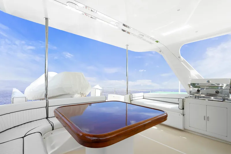  Yacht Photos Pics Luxurious 2007 Fleming 65 yacht deck with seating, table, and ocean view.