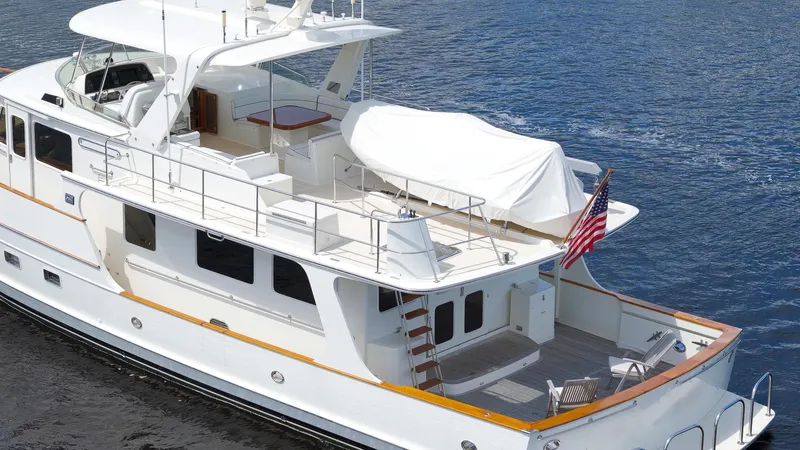  Yacht Photos Pics Luxury 2007 Fleming 65 yacht cruising on calm waters, featuring spacious deck and elegant design.