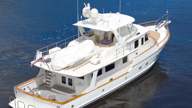  Yacht Photos Pics Luxury 2007 Fleming 65 yacht on calm blue water, showcasing elegant design and spacious deck.