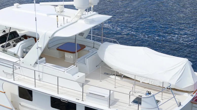  Yacht Photos Pics Luxury Fleming 65 yacht from 2007, featuring spacious deck and covered seating area.