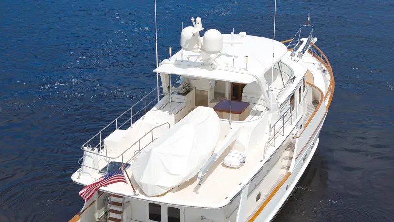  Yacht Photos Pics Luxury 2007 Fleming 65 yacht on calm blue water, featuring spacious deck and elegant design.