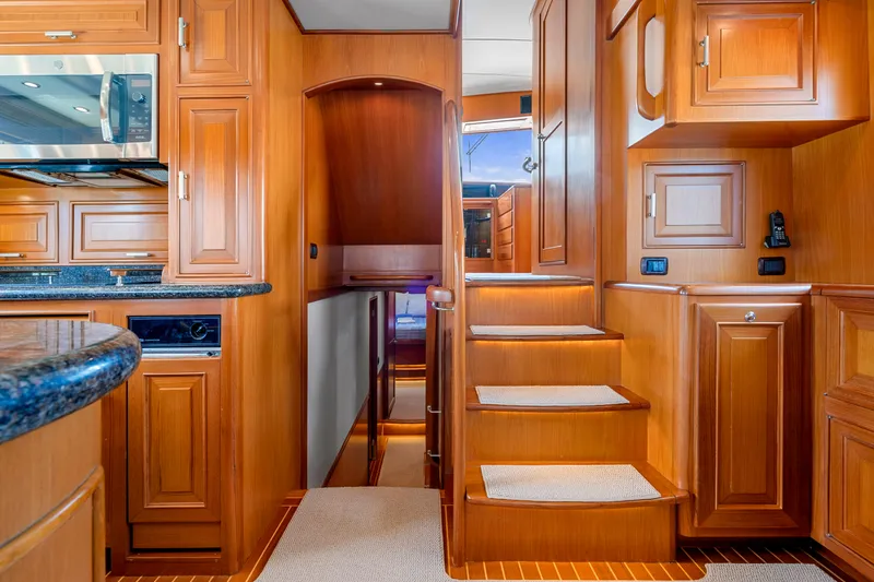  Yacht Photos Pics Luxurious wooden interior of a 2007 Fleming 65 yacht with stairs and cabinetry.