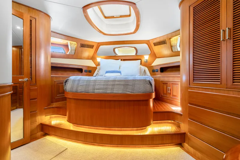  Yacht Photos Pics Luxurious cabin interior of 2007 Fleming 65 yacht with elegant wood finish and cozy bedding.