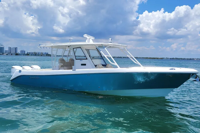  Yacht Photos Pics 2018 Everglades 355 Center Console boat on clear blue water under a cloudy sky.