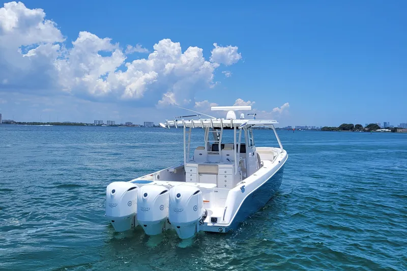  Yacht Photos Pics 2018 Everglades 355 Center Console boat on calm blue water under a clear sky.