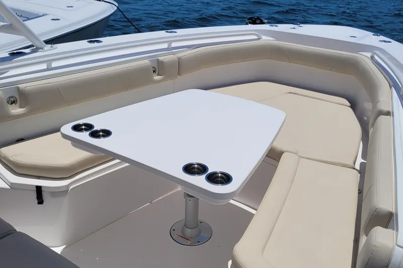  Yacht Photos Pics 2018 Everglades 355 Center Console boat with cushioned seating and table on open water.
