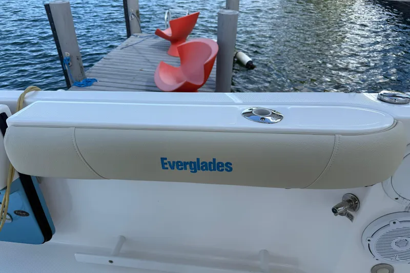  Yacht Photos Pics 2018 Everglades 355 Center Console boat with padded armrest, dock, and water view.