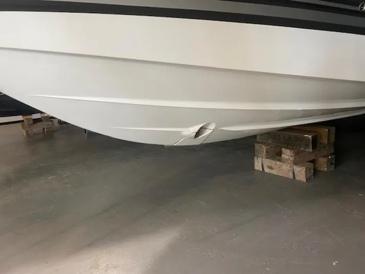  Yacht Photos Pics 2022 Monterey 295 Sport Yacht with hull damage on wooden blocks.