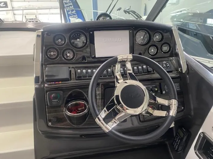  Yacht Photos Pics 2022 Monterey 295 Sport Yacht dashboard with modern controls and sleek steering wheel.