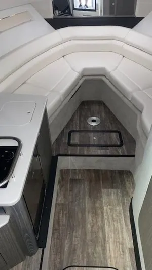  Yacht Photos Pics 2022 Monterey 295 Sport Yacht interior with white seating and wood flooring.