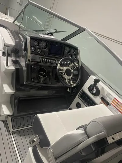  Yacht Photos Pics 2022 Monterey 295 Sport Yacht cockpit with modern controls and steering wheel.