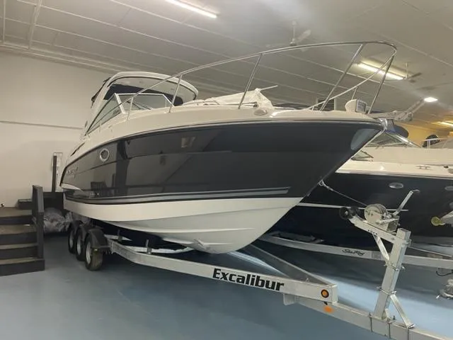  Yacht Photos Pics 2022 Monterey 295 Sport Yacht on Excalibur trailer in indoor showroom.