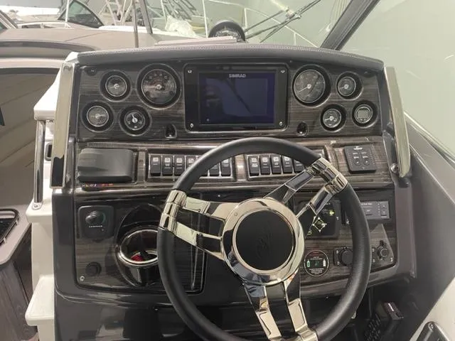  Yacht Photos Pics Dashboard of 2022 Monterey 295 Sport Yacht with modern controls and steering wheel.
