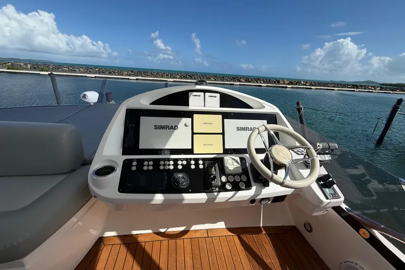 Lady A Yacht Photos Pics Helm of 2017 Sunseeker Manhattan 65 yacht with Simrad navigation system, docked by the sea.