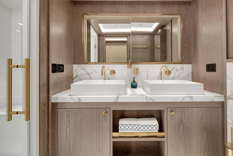  Yacht Photos Pics Luxurious bathroom in 2023 Sirena 88 yacht with dual sinks and elegant marble accents.