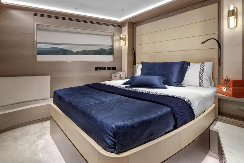  Yacht Photos Pics Luxurious bedroom interior of 2023 Sirena 88 yacht with elegant blue bedding.