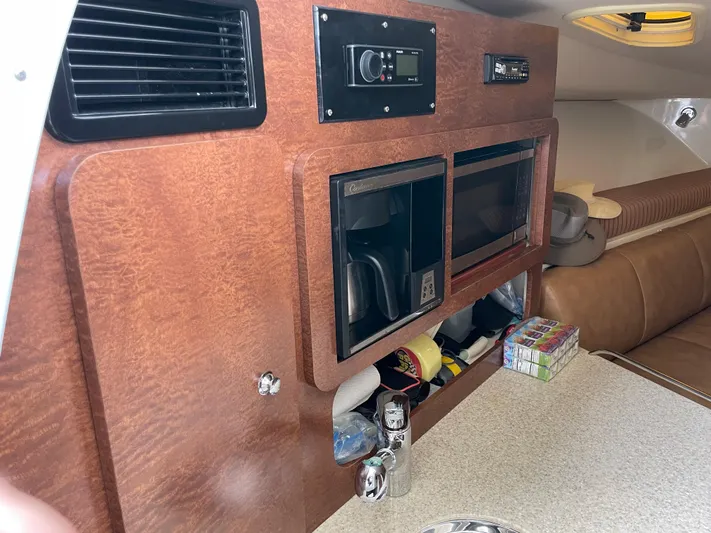  Yacht Photos Pics 2008 Hydra-Sports 3500VX cabin interior with microwave, storage, and seating area.