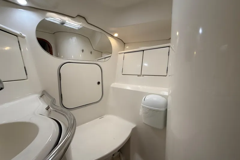 Fine Romance Yacht Photos Pics Bathroom interior of 1997 Beneteau Oceanis 40 CC yacht, featuring sleek white design.