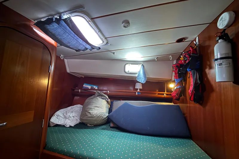 Fine Romance Yacht Photos Pics Cozy cabin interior of 1997 Beneteau Oceanis 40 CC sailboat with bedding and storage.
