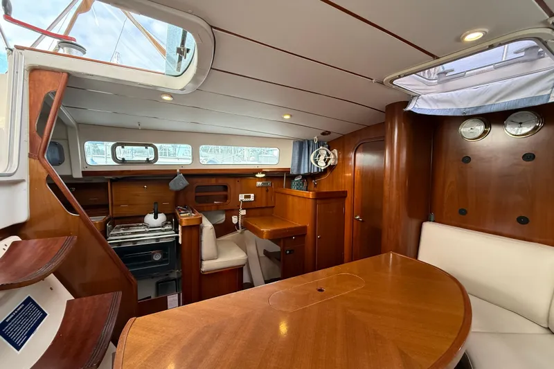 Fine Romance Yacht Photos Pics Interior of 1997 Beneteau Oceanis 40 CC sailboat with wood finish and dining area.