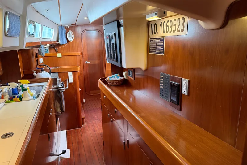 Fine Romance Yacht Photos Pics Interior of 1997 Beneteau Oceanis 40 CC yacht with wooden cabinetry and kitchen area.