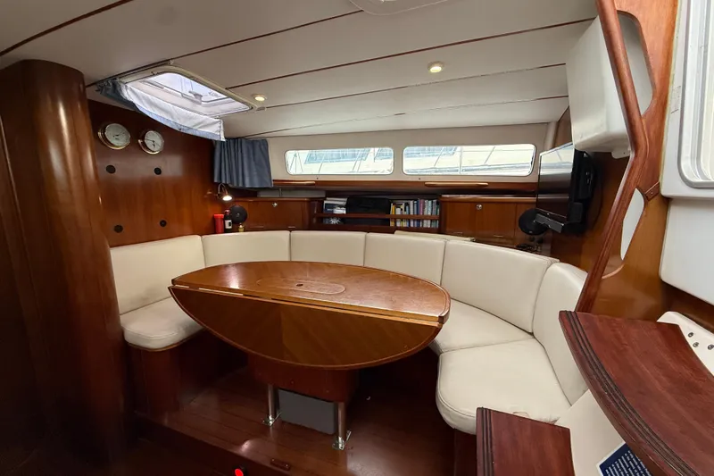 Fine Romance Yacht Photos Pics Interior of 1997 Beneteau Oceanis 40 CC sailboat with wood finish and curved seating.