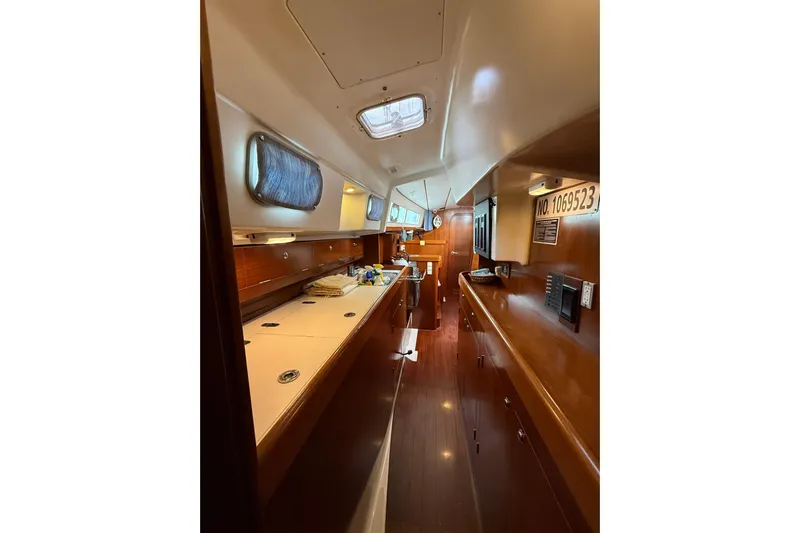 Fine Romance Yacht Photos Pics Interior of 1997 Beneteau Oceanis 40 CC sailboat, featuring wood finishes and compact design.