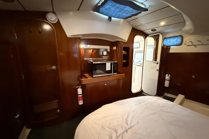 Fine Romance Yacht Photos Pics Interior of 1997 Beneteau Oceanis 40 CC yacht with wood finish and modern amenities.