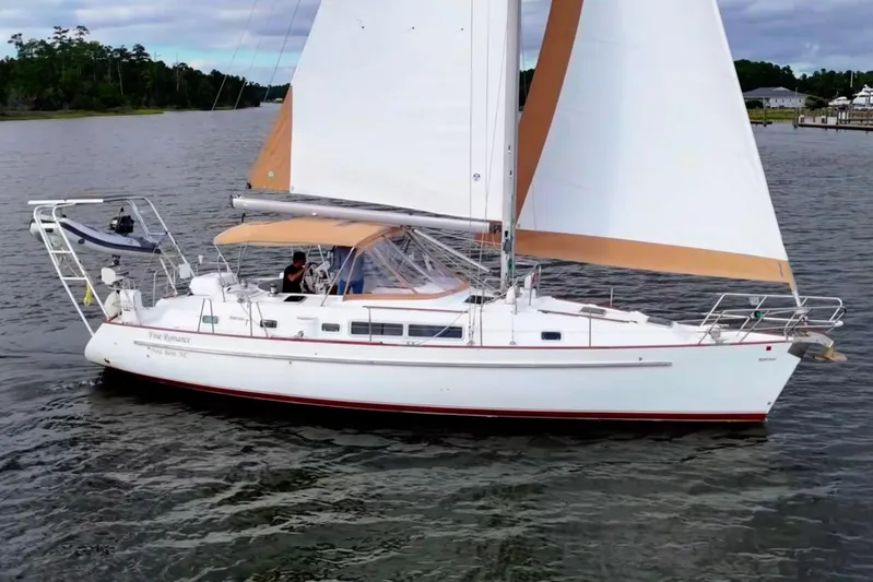 Fine Romance Yacht Photos Pics 1997 Beneteau Oceanis 40 CC sailboat cruising on calm waters.