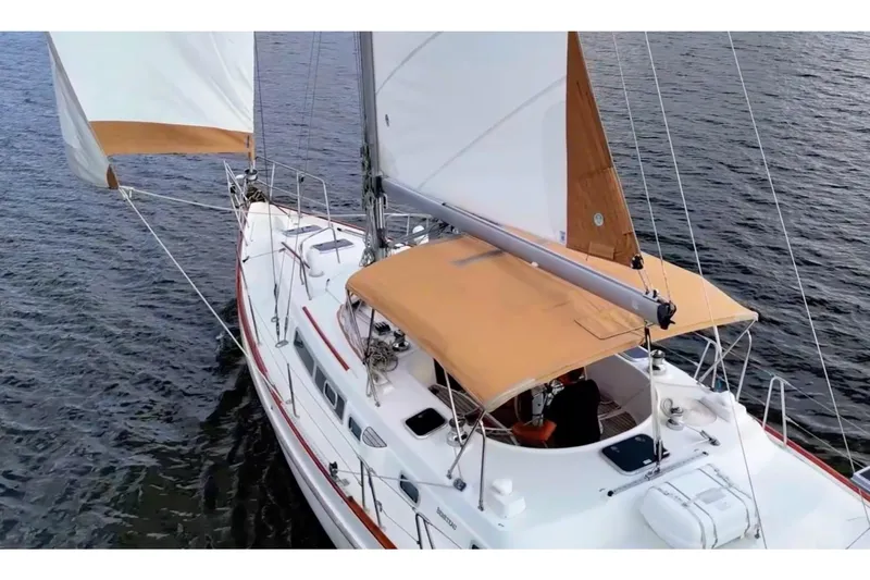 Fine Romance Yacht Photos Pics 1997 Beneteau Oceanis 40 CC sailing on calm waters, featuring tan sails and canopy.