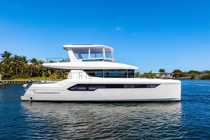 2022 Leopard 53 Powercat yacht on calm water, clear blue sky background.