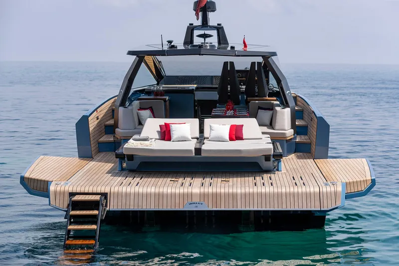  Yacht Photos Pics Luxury 2022 Wally WALLYPOWER58 yacht with elegant deck and sun loungers on calm sea.