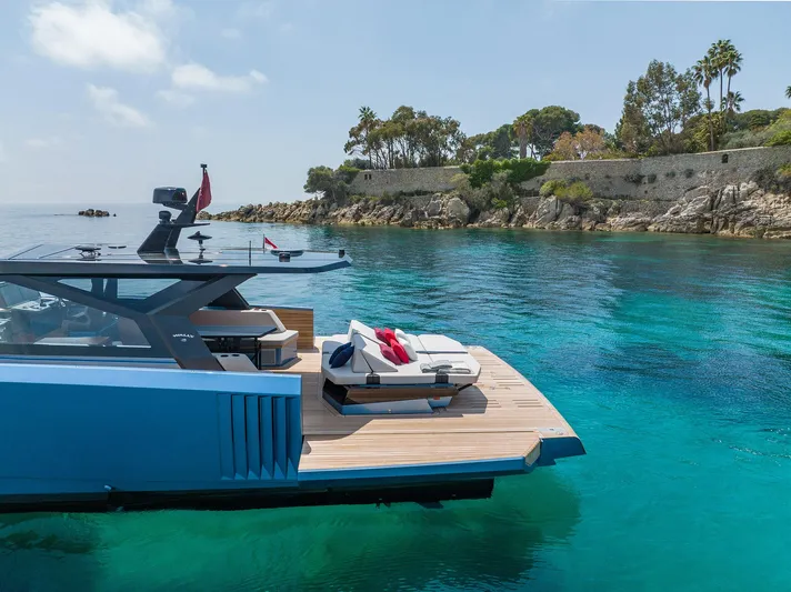  Yacht Photos Pics Luxury 2022 Wally WALLYPOWER58 yacht docked in clear turquoise waters.