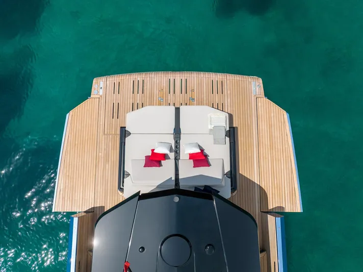  Yacht Photos Pics Luxurious 2022 Wally WALLYPOWER58 yacht deck with sun loungers and cushions on turquoise water.