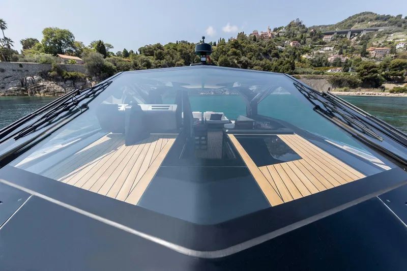  Yacht Photos Pics 2022 Wally WALLYPOWER58 yacht with sleek design, glass roof, and scenic coastal backdrop.