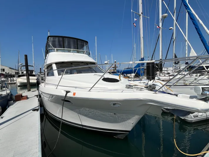  Yacht Photos Pics 1996 Bayliner 3788 Command Bridge Motoryacht docked at marina under clear blue sky.