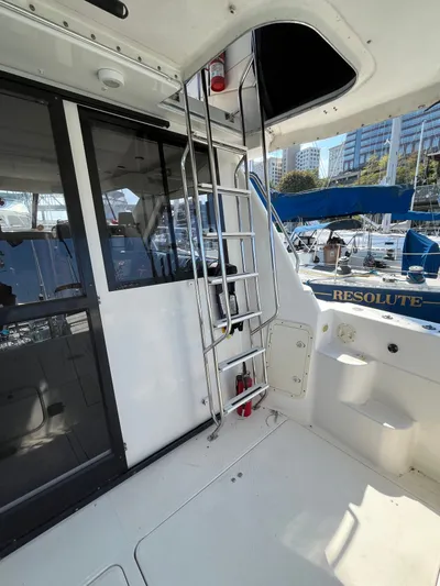  Yacht Photos Pics 1996 Bayliner 3788 Command Bridge Motoryacht with ladder and marina view.